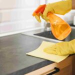 close-up-hands-cleaning-cabinet